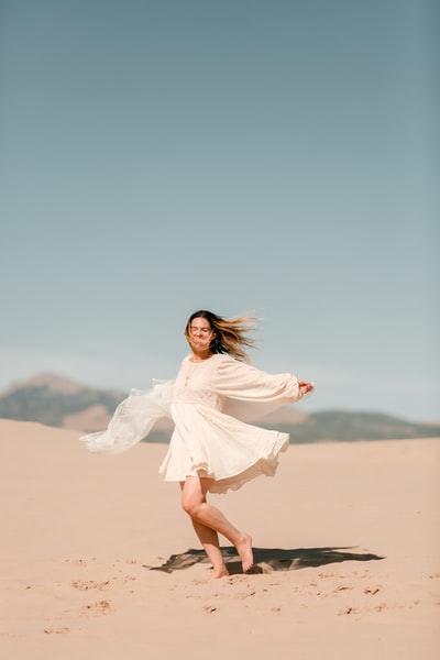 White woman standing in the desert

